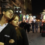 I love this shot of their stroll with the midnight market in the background.